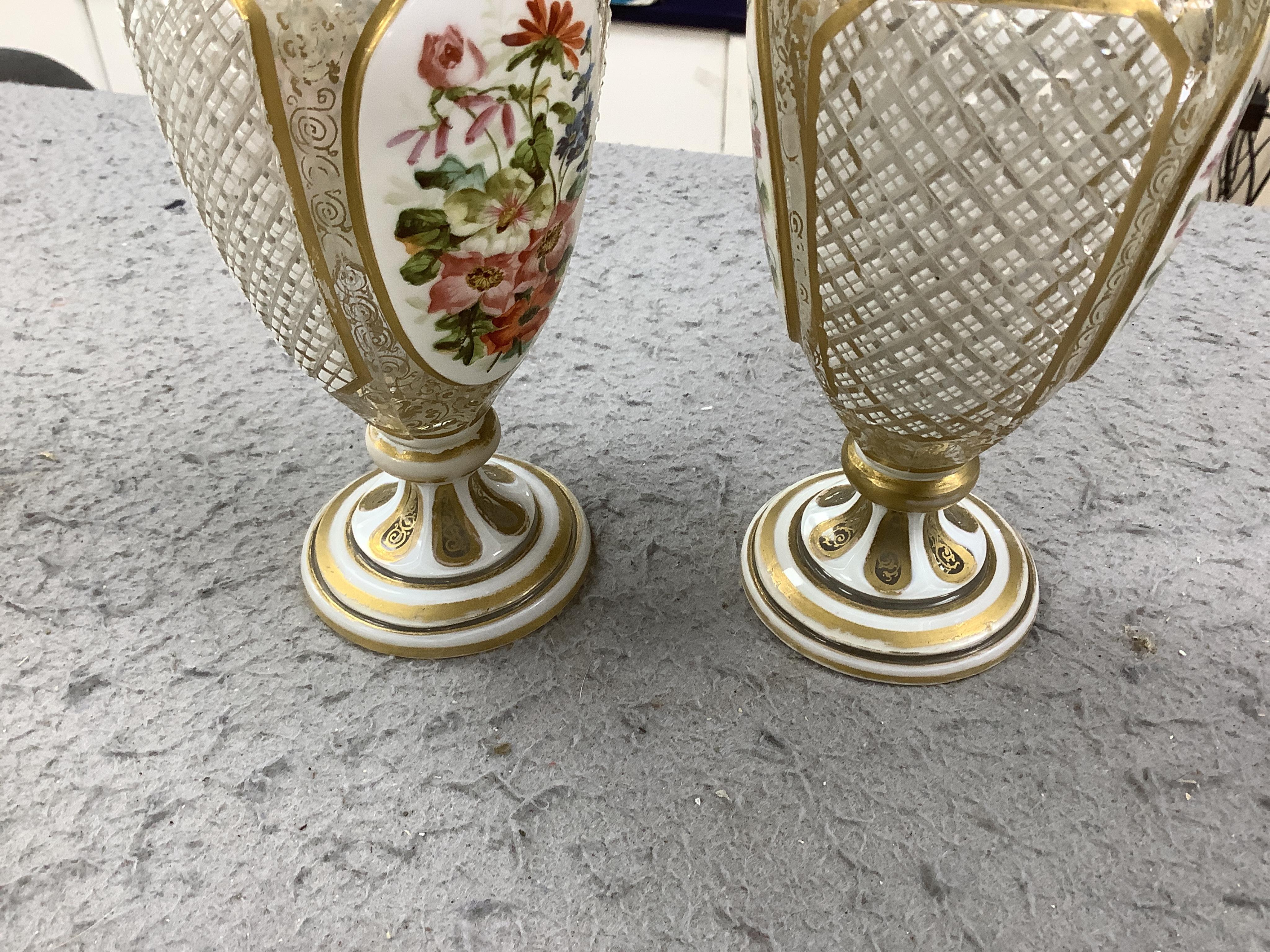 A pair of late 19th century Bohemian enamelled overlaid glass vases, and a similar overlaid glass comport. Condition - vases fair; comport poor